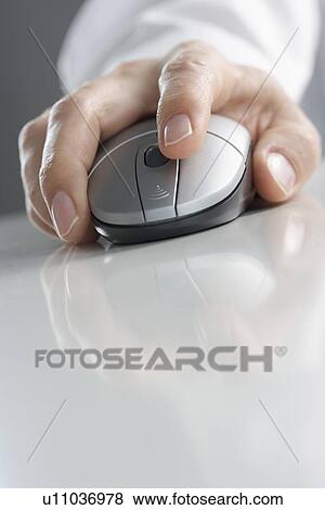 Stock Photo - Hand on computer mouse with reflection. Fotosearch