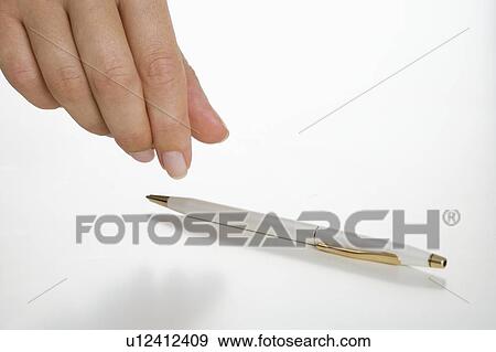 Stock Photo - Hand picking up pen. Fotosearch