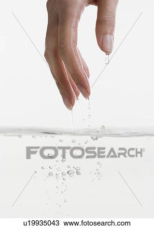 Hand touching water View Large Photo Image Stock Image - Hand touching water. Fotosearch