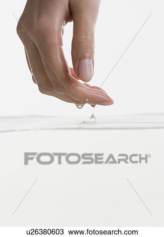 Stock Image - Hand touching water. Fotosearch