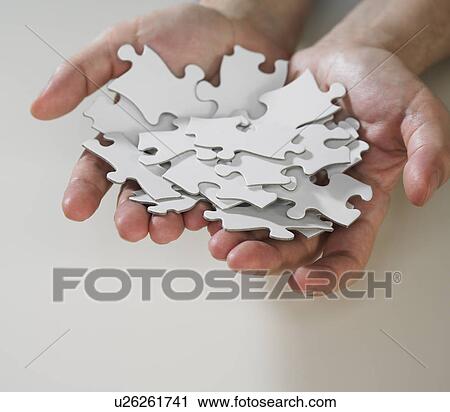 Hands holding puzzle pieces View Large Photo Image Stock Image - Hands holding puzzle pieces. Fotosearch