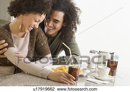 Stock Image - Happy couple in a restaurant. Fotosearch
