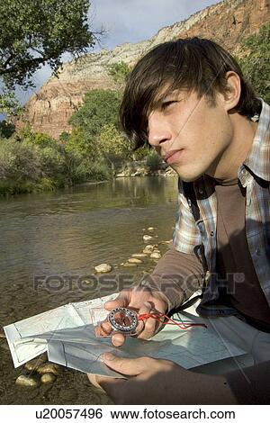 Hiker checking his map View Large Photo Image Stock Photograph - Hiker checking his map. Fotosearch