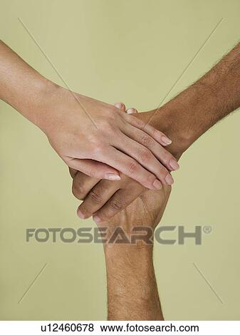 Stock Photo - Holding hands in multiracial group. Fotosearch