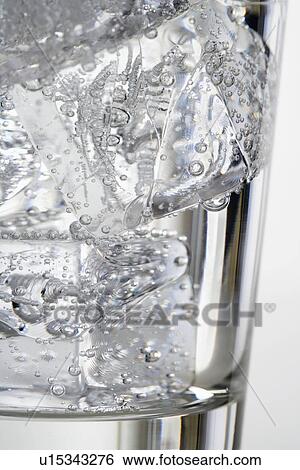 Ice cubes in a glass View Large Photo Image Stock Photograph - Ice cubes in a glass. Fotosearch