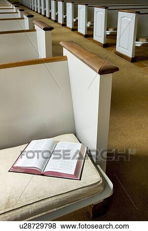 Interior of a church with Bible on a pew View Large Photo Image Stock Photo - Interior of a church with Bible on a pew. Fotosearch