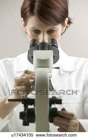 Lab technician at a microscope View Large Photo Image Stock Photography - Lab technician at a microscope. Fotosearch