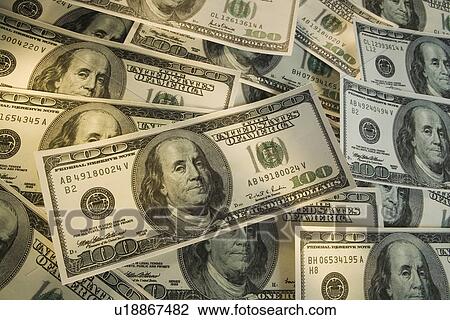 Stock Image - Large group of American one hundred dollar bills. Fotosearch