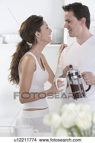 Laughing young couple with coffee View Large Photo Image Picture - Laughing young couple with coffee. Fotosearch