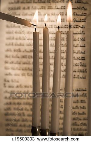Lighting a menorah View Large Photo Image Stock Image - Lighting a menorah. Fotosearch