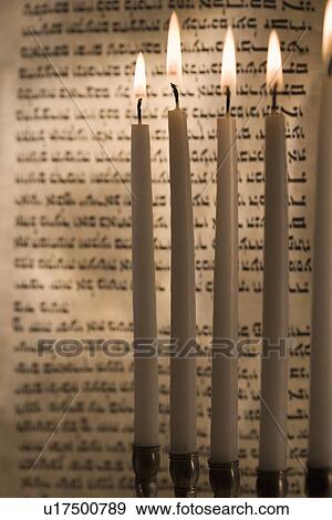 Stock Photo - Lighting a menorah. Fotosearch