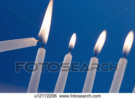 Stock Photograph - Lighting a menorah. Fotosearch