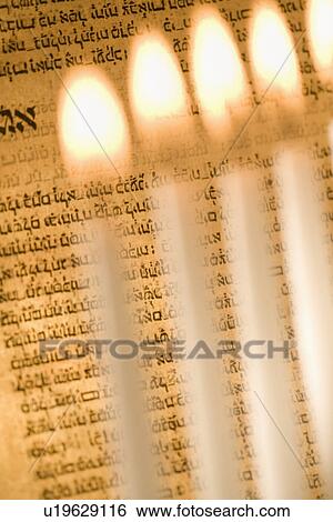Lighting a menorah View Large Photo Image Stock Photograph - Lighting a menorah. Fotosearch