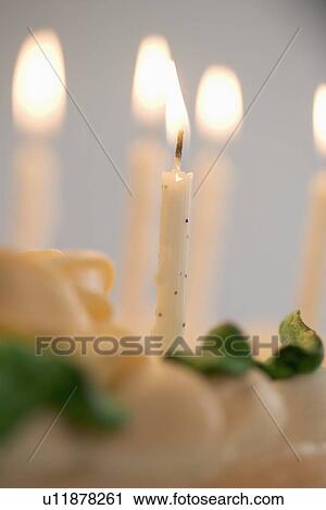 Lit candles on a birthday cake View Large Photo Image Stock Image - Lit candles on a birthday cake. Fotosearch
