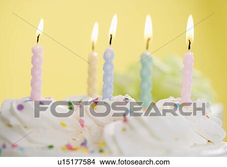 Lit candles on a cake View Large Photo Image Picture - Lit candles on a cake. Fotosearch