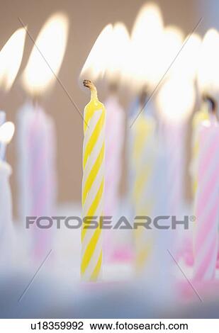 Stock Image - Lit candles on a cake. Fotosearch