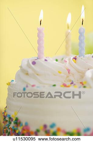 Lit candles on a cake View Large Photo Image Stock Photography - Lit candles on a cake. Fotosearch