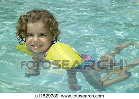 Little girl swimming View Large Photo Image Stock Photo - Little girl swimming. Fotosearch