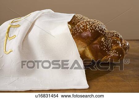 Picture - Loaf of Challah bread under cloth. Fotosearch