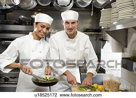 Male and female chefs in restaurant kitchen View Large Photo Image Stock Image - Male and female chefs in restaurant kitchen. Fotosearch