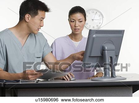 Stock Photograph - Male and female healthcare workers. Fotosearch