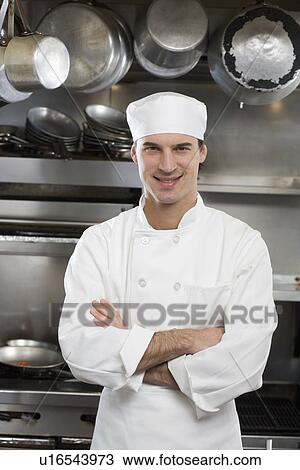 Stock Image - Male chef in restaurant kitchen. Fotosearch