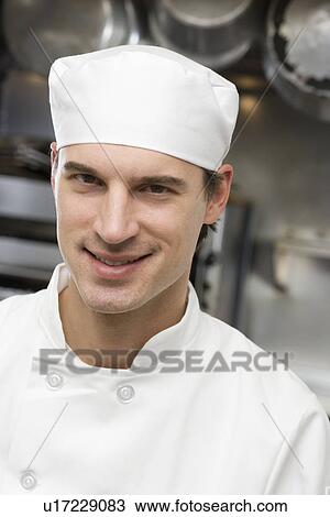 Stock Image - Male chef in restaurant kitchen. Fotosearch