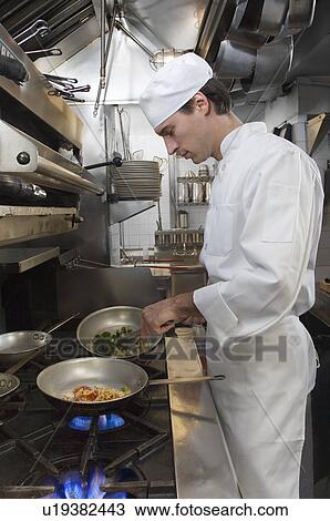 Male chef in restaurant kitchen View Large Photo Image Stock Image - Male chef in restaurant kitchen. Fotosearch