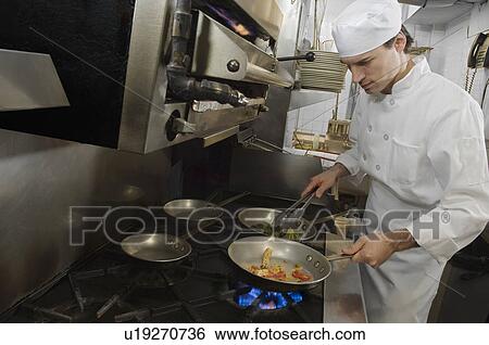 Male chef in restaurant kitchen View Large Photo Image Stock Photograph - Male chef in restaurant kitchen. Fotosearch