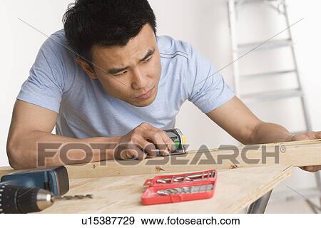 Man doing home repairs View Large Photo Image Stock Photo - Man doing home repairs. Fotosearch