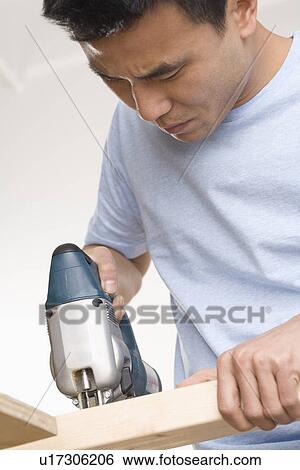 Man doing home repairs View Large Photo Image Stock Photograph - Man doing home repairs. Fotosearch
