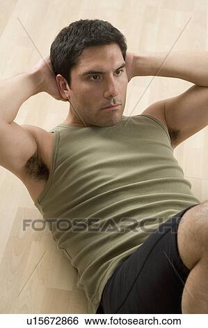 Stock Photograph - Man doing sit-ups. Fotosearch