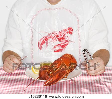 Man eating a lobster View Large Photo Image Stock Photo - Man eating a lobster. Fotosearch
