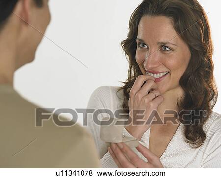 Stock Photo - Man giving woman engagement ring. Fotosearch