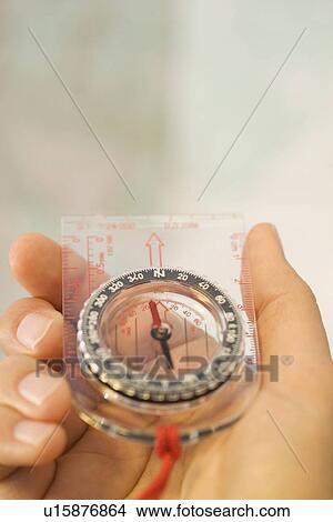 Man holding a compass View Large Photo Image Picture - Man holding a compass. Fotosearch