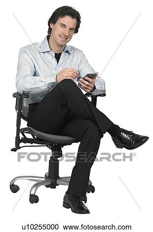 Stock Image - Man holding a PDA. Fotosearch