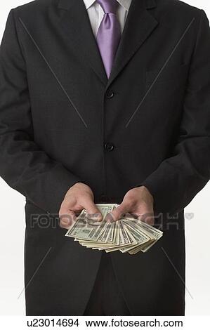 Picture - Man holding American money. Fotosearch