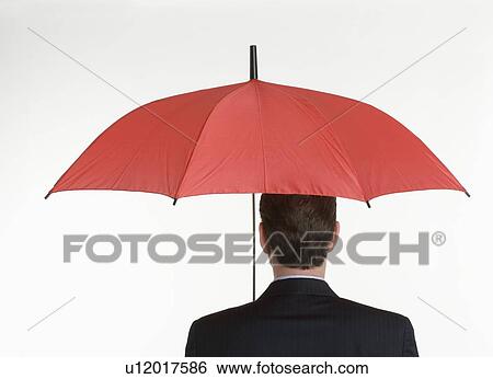Stock Photograph - Man holding an umbrella. Fotosearch