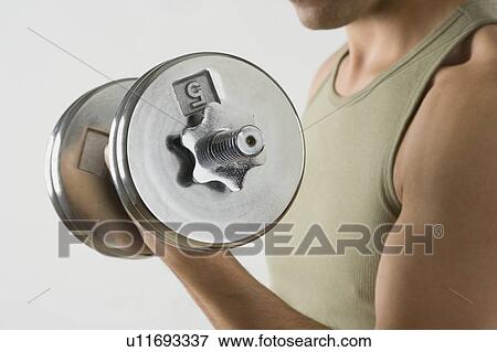 Stock Photo - Man lifting weights. Fotosearch