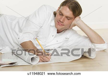 Man looking at blueprints View Large Photo Image Stock Image - Man looking at blueprints. Fotosearch