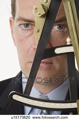 Man looking through an octant View Large Photo Image Stock Image - Man looking through an octant. Fotosearch