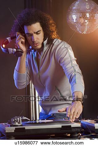 Stock Photo - Man mixing sound at a dance club. Fotosearch