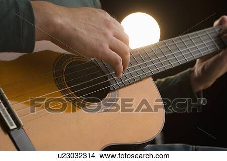 Picture - Man playing guitar. Fotosearch