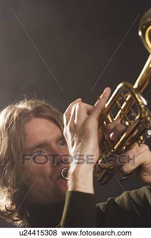 Man playing horn View Large Photo Image Stock Photo - Man playing horn. Fotosearch