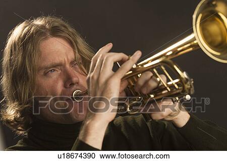 Stock Image - Man playing the trumpet. Fotosearch