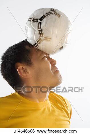 Stock Photograph - Man playing with soccer ball. Fotosearch
