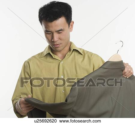 Stock Image - Man shopping for a sport coat. Fotosearch