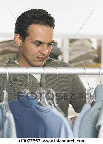 Man shopping for clothes View Large Photo Image Stock Photo - Man shopping for clothes. Fotosearch