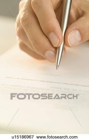 Stock Photo - Man signing a document. Fotosearch