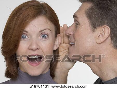 Man telling woman surprising secret View Large Photo Image Stock Image - Man telling woman surprising secret. Fotosearch